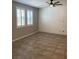 Bright living room featuring tile flooring, plantation shutters, and a modern ceiling fan at 1197 Mission View Ct, Henderson, NV 89002