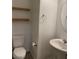 Neat powder room featuring a pedestal sink, modern fixtures, and floating shelves at 1197 Mission View Ct, Henderson, NV 89002