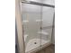 Bright shower featuring sliding glass door and built in seating at 1197 Mission View Ct, Henderson, NV 89002