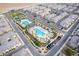Aerial view of a community with a swimming pool, palm trees, a park, and townhomes at 12108 Harvest Sky Way # 1, Las Vegas, NV 89183