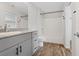 Bright bathroom with a granite countertop, tub-shower combo and wood look flooring at 12108 Harvest Sky Way # 1, Las Vegas, NV 89183