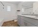 Charming bathroom with wood look flooring, granite counters, tub-shower combo, and window at 12108 Harvest Sky Way # 1, Las Vegas, NV 89183