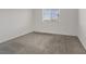Bright, carpeted bedroom with a view from the window at 12108 Harvest Sky Way # 1, Las Vegas, NV 89183