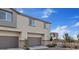 Exterior elevation of modern townhomes with attached garages and well-maintained landscaping at 12108 Harvest Sky Way # 1, Las Vegas, NV 89183
