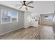 Bright and airy living room with wood floors and natural light from a large window at 12108 Harvest Sky Way # 1, Las Vegas, NV 89183