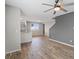 Open-concept living room with wood floors and an open view into the kitchen and stairs at 12108 Harvest Sky Way # 1, Las Vegas, NV 89183