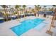 Community pool with lounge chairs, palm trees, and a cabana at 12108 Harvest Sky Way # 1, Las Vegas, NV 89183