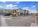 Street view of modern townhomes with attached garages and manicured landscaping at 12108 Harvest Sky Way # 1, Las Vegas, NV 89183