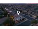 A beautiful aerial view of a home in a community with a view of the city skyline at dusk at 1283 Peppercorn Ave, Henderson, NV 89012