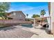 Gorgeous backyard oasis featuring a sparkling pool, covered patio, and lush landscaping at 1283 Peppercorn Ave, Henderson, NV 89012