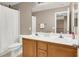 Bathroom with dual vanity, wood cabinets, and white shower curtain at 1283 Peppercorn Ave, Henderson, NV 89012