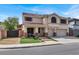 Charming two-story home featuring a tile roof, manicured landscaping, and a two-car garage at 1283 Peppercorn Ave, Henderson, NV 89012