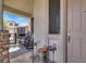 Inviting covered front porch with stone accents, rocking chairs, and a decorative outdoor rug at 1283 Peppercorn Ave, Henderson, NV 89012