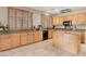 Well-lit kitchen features ample cabinet space, granite countertops, a center island, and modern appliances for cooking at 1283 Peppercorn Ave, Henderson, NV 89012