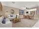 Comfortable living room with neutral tones, a dining area, and large windows that fill the space with natural light at 1283 Peppercorn Ave, Henderson, NV 89012