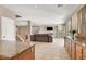 Bright, open-concept living room features tile floors, stacked stone wall, and access to the backyard at 1283 Peppercorn Ave, Henderson, NV 89012