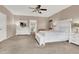 Spacious main bedroom with neutral colors, a ceiling fan, and an ensuite bathroom at 1283 Peppercorn Ave, Henderson, NV 89012