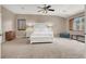 Spacious main bedroom featuring neutral colors, plush carpeting, and a large window at 1283 Peppercorn Ave, Henderson, NV 89012