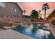 Beautiful backyard pool featuring waterfalls, fire pits, and lush landscaping, perfect for outdoor relaxation and entertaining at 1283 Peppercorn Ave, Henderson, NV 89012