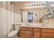 Well-lit bathroom featuring double sinks and a shower with white curtain at 1375 E Hacienda Ave # 114, Las Vegas, NV 89119
