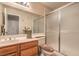 Bathroom with wood vanity, shower with sliding glass doors and large mirror at 1375 E Hacienda Ave # 114, Las Vegas, NV 89119
