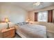 Bright bedroom with a ceiling fan, neutral decor, and large window at 1375 E Hacienda Ave # 114, Las Vegas, NV 89119