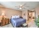 Inviting bedroom with soft bedding, a ceiling fan, and warm ambient lighting at 1375 E Hacienda Ave # 114, Las Vegas, NV 89119