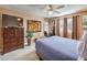 Cozy bedroom featuring a TV, eclectic decor, and comfortable carpet at 1375 E Hacienda Ave # 114, Las Vegas, NV 89119