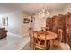 Dining area with a chandelier, wooden furniture, and decorative screen at 1375 E Hacienda Ave # 114, Las Vegas, NV 89119