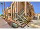 Exterior view of apartment building with stairs leading to upper units and desert landscaping at 1375 E Hacienda Ave # 114, Las Vegas, NV 89119