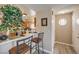 Open concept kitchen with breakfast bar, oak cabinets, and view into entry way at 1375 E Hacienda Ave # 114, Las Vegas, NV 89119