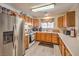 Functional kitchen featuring stainless steel appliances and warm wood cabinets at 1375 E Hacienda Ave # 114, Las Vegas, NV 89119