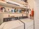Laundry room equipped with washer, dryer and storage shelves at 1375 E Hacienda Ave # 114, Las Vegas, NV 89119