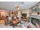Cozy living room featuring a fireplace and comfortable leather furniture, with dining area beyond at 1375 E Hacienda Ave # 114, Las Vegas, NV 89119