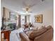 Comfortable living room with a fireplace, ceiling fan, and plush brown leather furniture at 1375 E Hacienda Ave # 114, Las Vegas, NV 89119