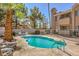 Inviting community pool area with lounge chairs and lush green landscaping at 1375 E Hacienda Ave # 114, Las Vegas, NV 89119