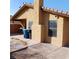 View of the home's backyard patio with textured stucco and window at 1732 Yellow Rose St, Las Vegas, NV 89108