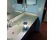 Bathroom vanity featuring a basic design with a sink, mirror, and minimal countertop space with a lantern on top at 1732 Yellow Rose St, Las Vegas, NV 89108