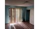 A bedroom with light streaming through vertical blinds at 1732 Yellow Rose St, Las Vegas, NV 89108