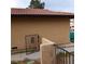 Exterior view of a home with a stucco wall, a tiled roof, a wrought iron gate and block wall at 1732 Yellow Rose St, Las Vegas, NV 89108