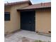 Exterior view of a home featuring a tiled roof, stucco walls, and a black wrought iron security gate at 1732 Yellow Rose St, Las Vegas, NV 89108