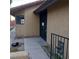 Home's entry with a secure door, window, and stucco exterior at 1732 Yellow Rose St, Las Vegas, NV 89108