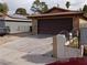 View of the home's exterior showing a spacious driveway and two-car garage at 1732 Yellow Rose St, Las Vegas, NV 89108