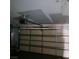 A garage with metal sectional door and automatic door opener at 1732 Yellow Rose St, Las Vegas, NV 89108