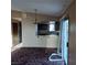 Living room with an opening to a cozy kitchenette with laminate countertops at 1732 Yellow Rose St, Las Vegas, NV 89108