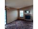 Living room with a fireplace, natural light, and sliding glass doors to the outside at 1732 Yellow Rose St, Las Vegas, NV 89108