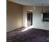 Open-concept living room with an opening to the kitchen and vintage light fixture at 1732 Yellow Rose St, Las Vegas, NV 89108
