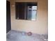 Rear patio with window, stucco, and two basketballs on the ground at 1732 Yellow Rose St, Las Vegas, NV 89108