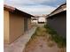 View of a side yard featuring desert landscaping, with neighboring houses visible in the background at 1732 Yellow Rose St, Las Vegas, NV 89108