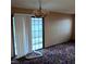 Living room with sliding glass doors and a vintage hanging light fixture at 1732 Yellow Rose St, Las Vegas, NV 89108